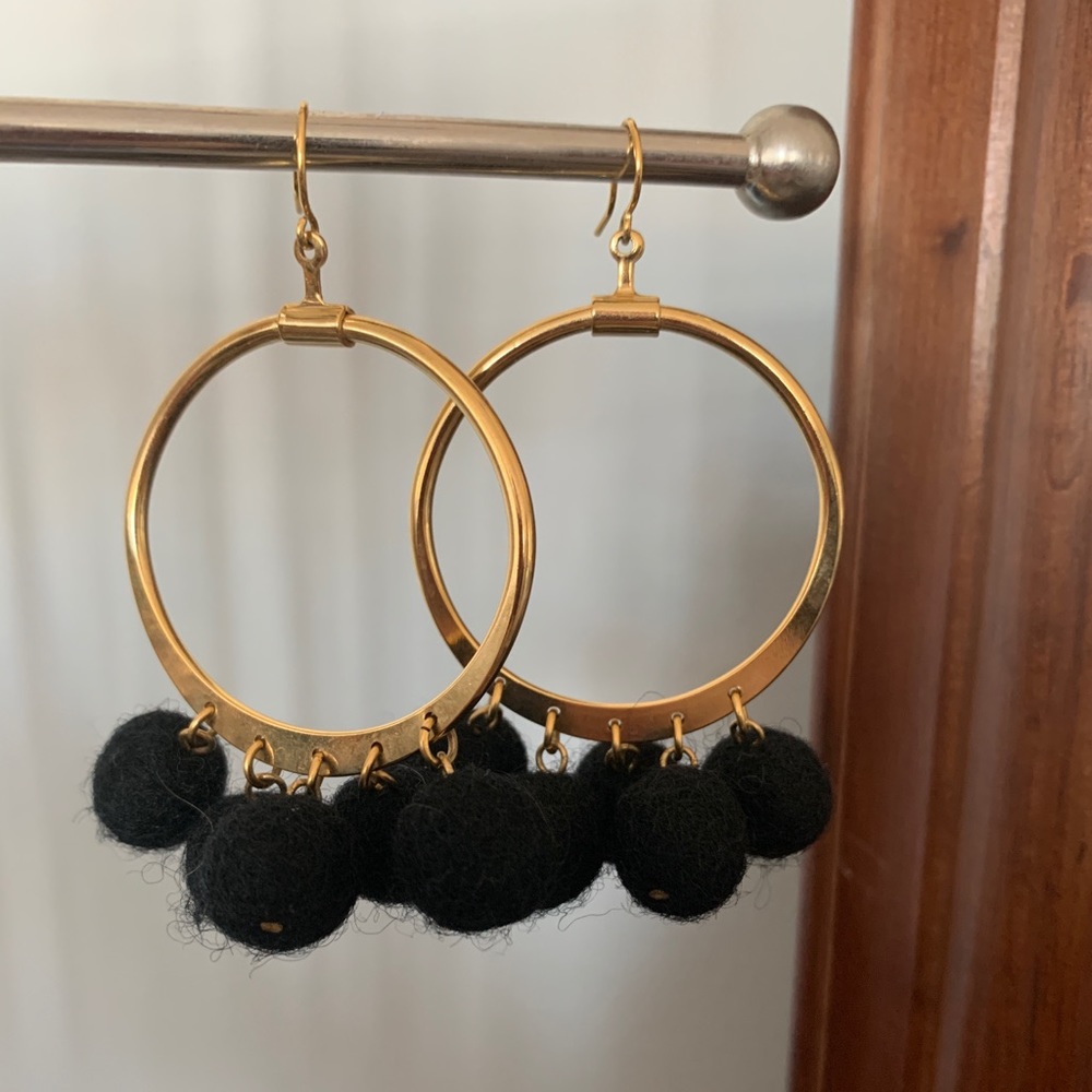 Gold hoop earrings with black wool felt drops
